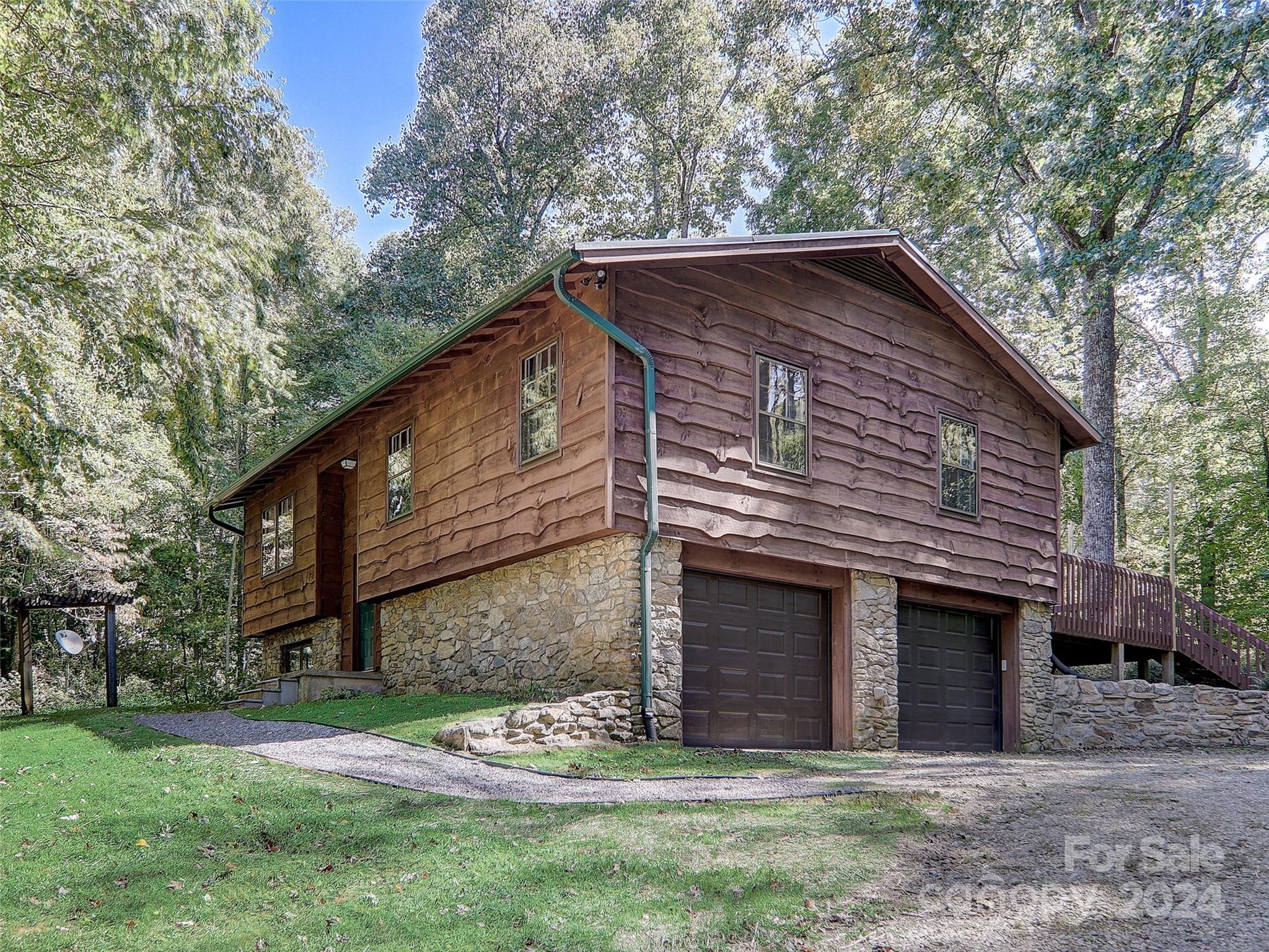 1191 Dupont Road Hendersonville, NC 28739 - Photo 2 of 48 a brick house with a small yard and large trees