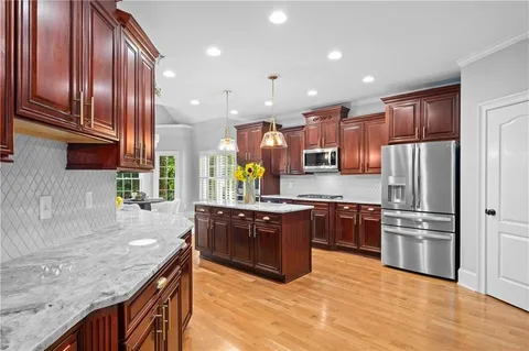 a dining room with furniture window and wooden floor