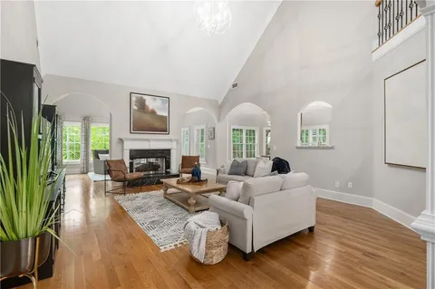 a spacious bedroom with a bed and a flat screen tv