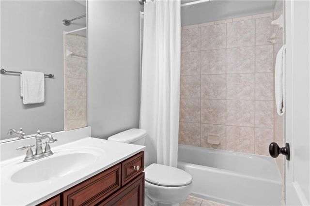 a view of an empty room with wooden floor and closet