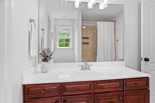 a kitchen with stainless steel appliances granite countertop a sink a stove a refrigerator a center island and cabinets