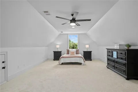 a room with wooden floor pool table and windows
