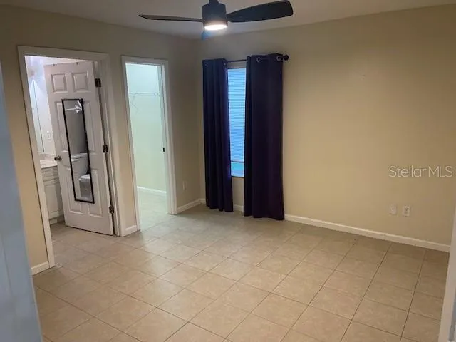 an empty room with closet and mirror