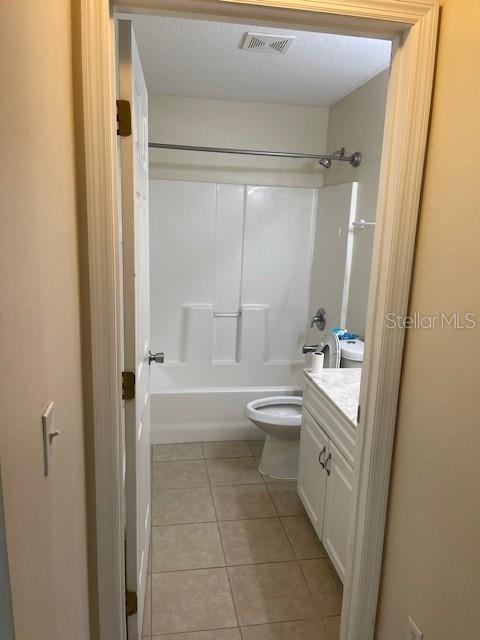 38 Pine Hurst Lane, Unit B Palm Coast, FL 32164 - Photo 8 of 11 a bathroom with a granite countertop sink toilet and shower