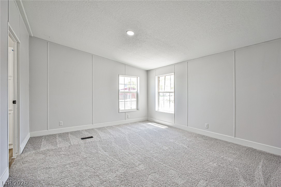 273 Aztec Lane Henderson, NV 89015 - Photo 15 of 28 Bright windows illuminate this airy, neutral-toned room with plush carpet.