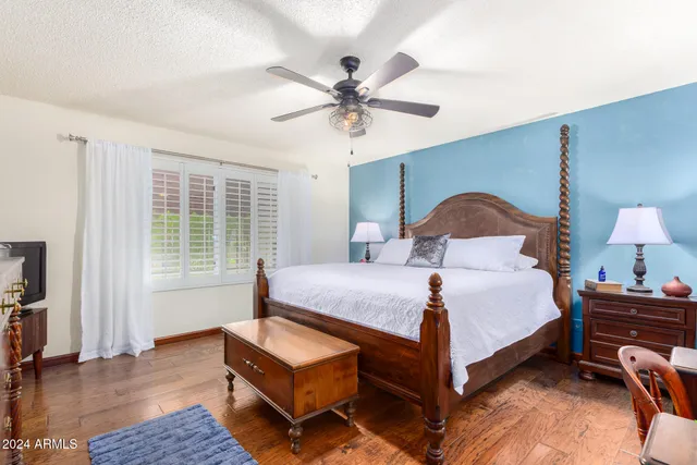 a bedroom with a bed lamp closet and large window