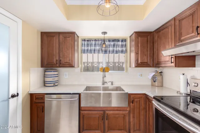 a kitchen with stainless steel appliances a sink stove and cabinets