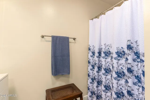 a bathroom with a shower curtain and a large window