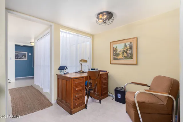 a view of workspace with furniture and window