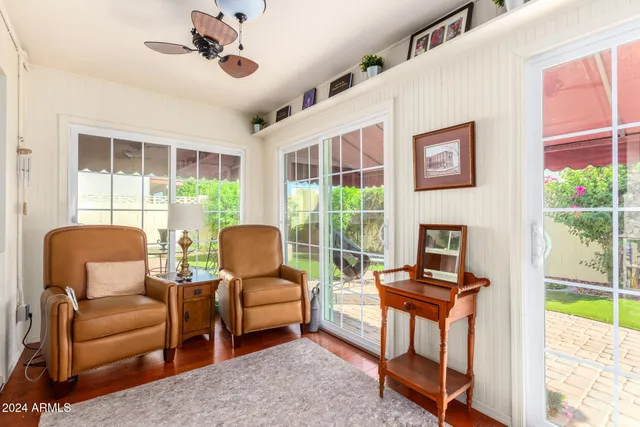 a living room with furniture and a floor to ceiling window