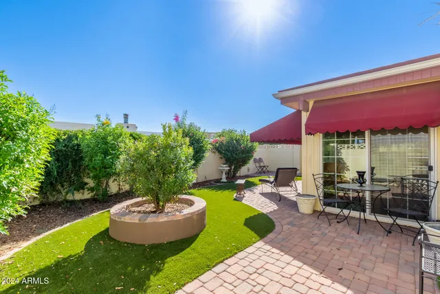 a swimming pool with outdoor seating and yard