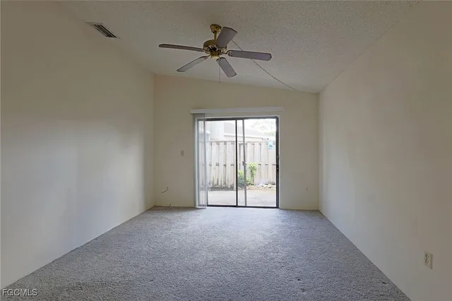a view of a livingroom with a ceiling fan and window