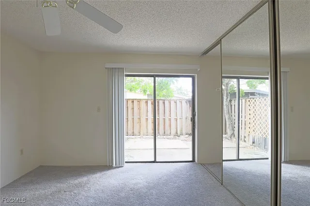 an empty room with sliding glass door and glass door