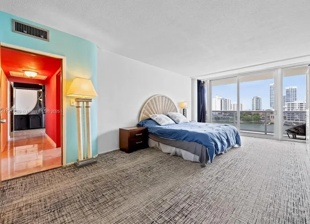 a bedroom with a bed and a mirror