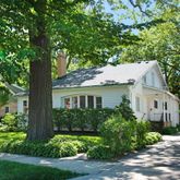 a house that has a tree in front of the house