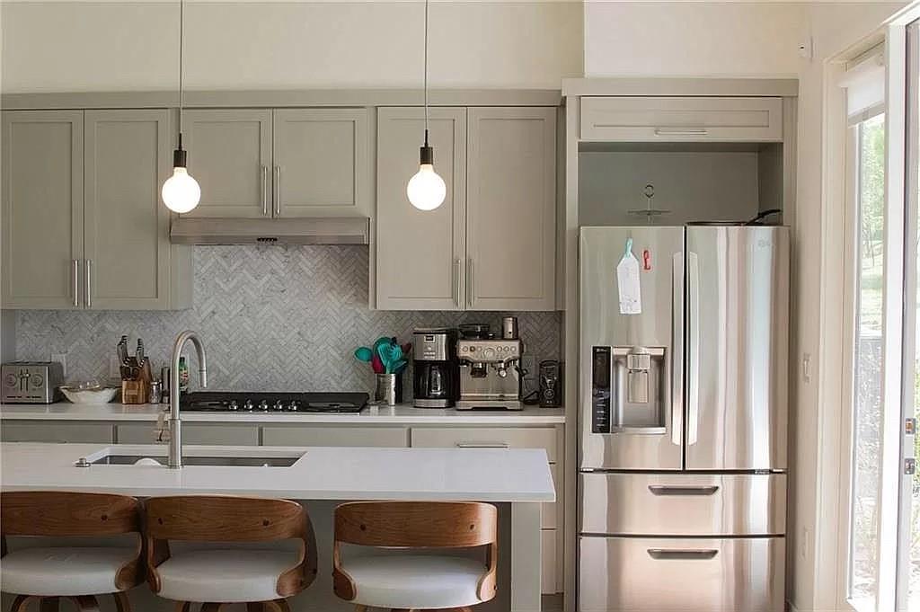 2519 Sutherland Street Austin, TX 78746 - Photo 2 of 14 a kitchen with a sink and refrigerator