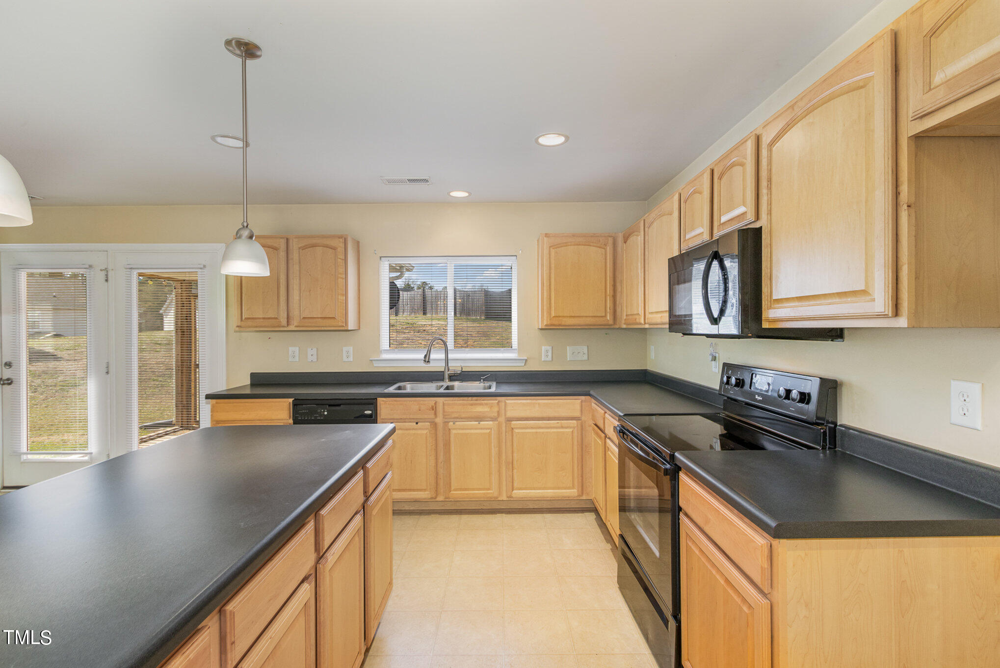 650 Conover Road Durham, NC 27703 - Photo 11 of 25 a kitchen with stainless steel appliances granite countertop a sink a stove and cabinets