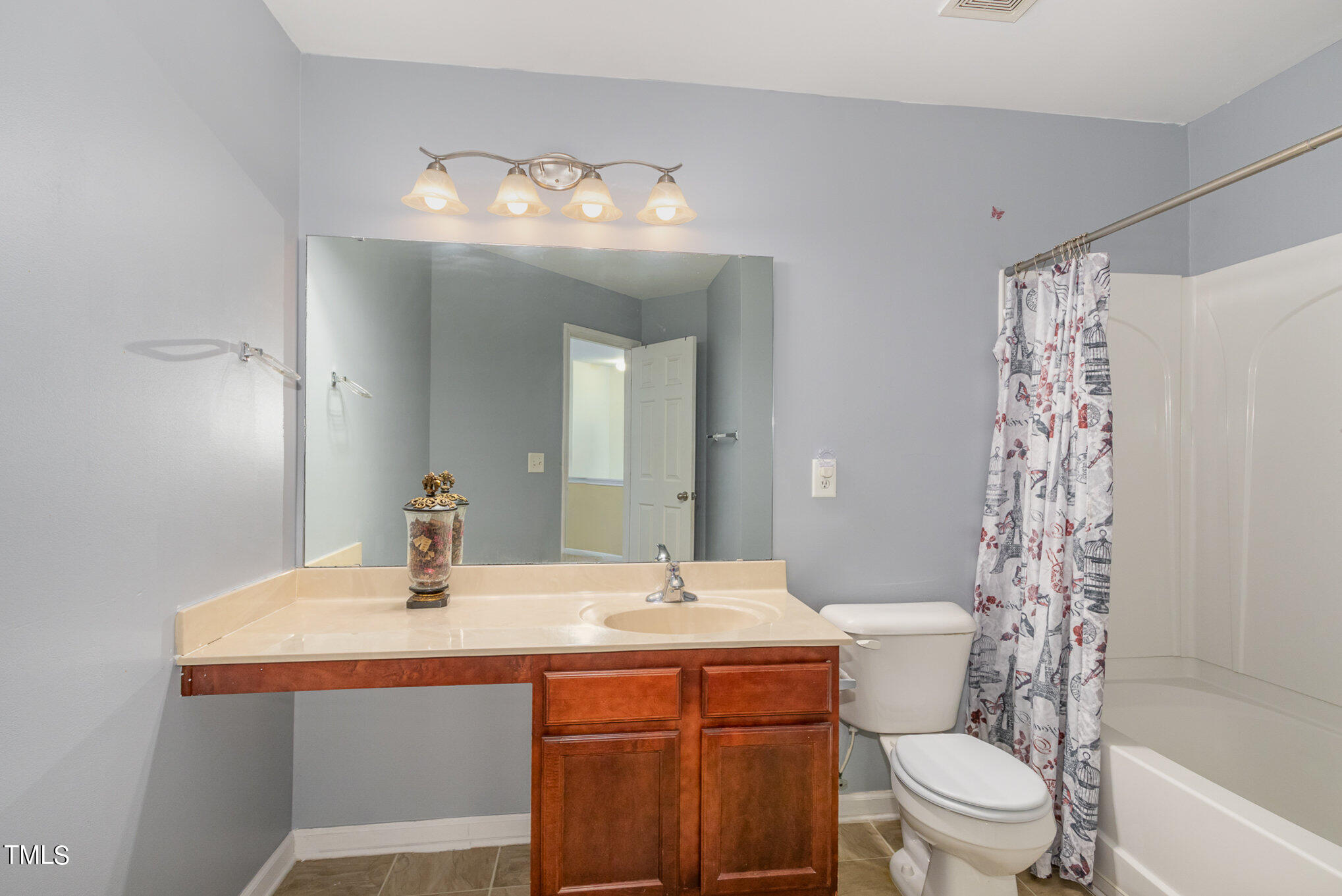 650 Conover Road Durham, NC 27703 - Photo 14 of 25 a bathroom with a sink toilet and shower