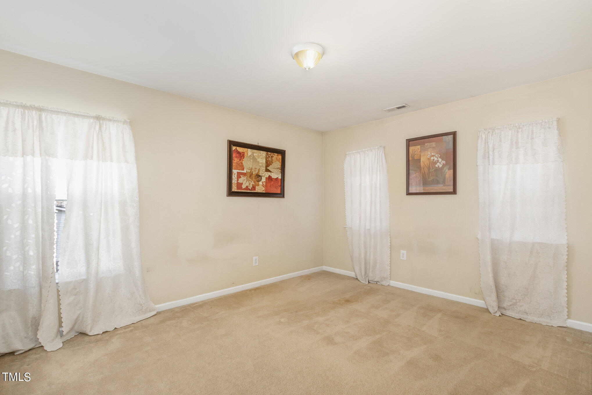 650 Conover Road Durham, NC 27703 - Photo 17 of 25 an empty room with windows and closet