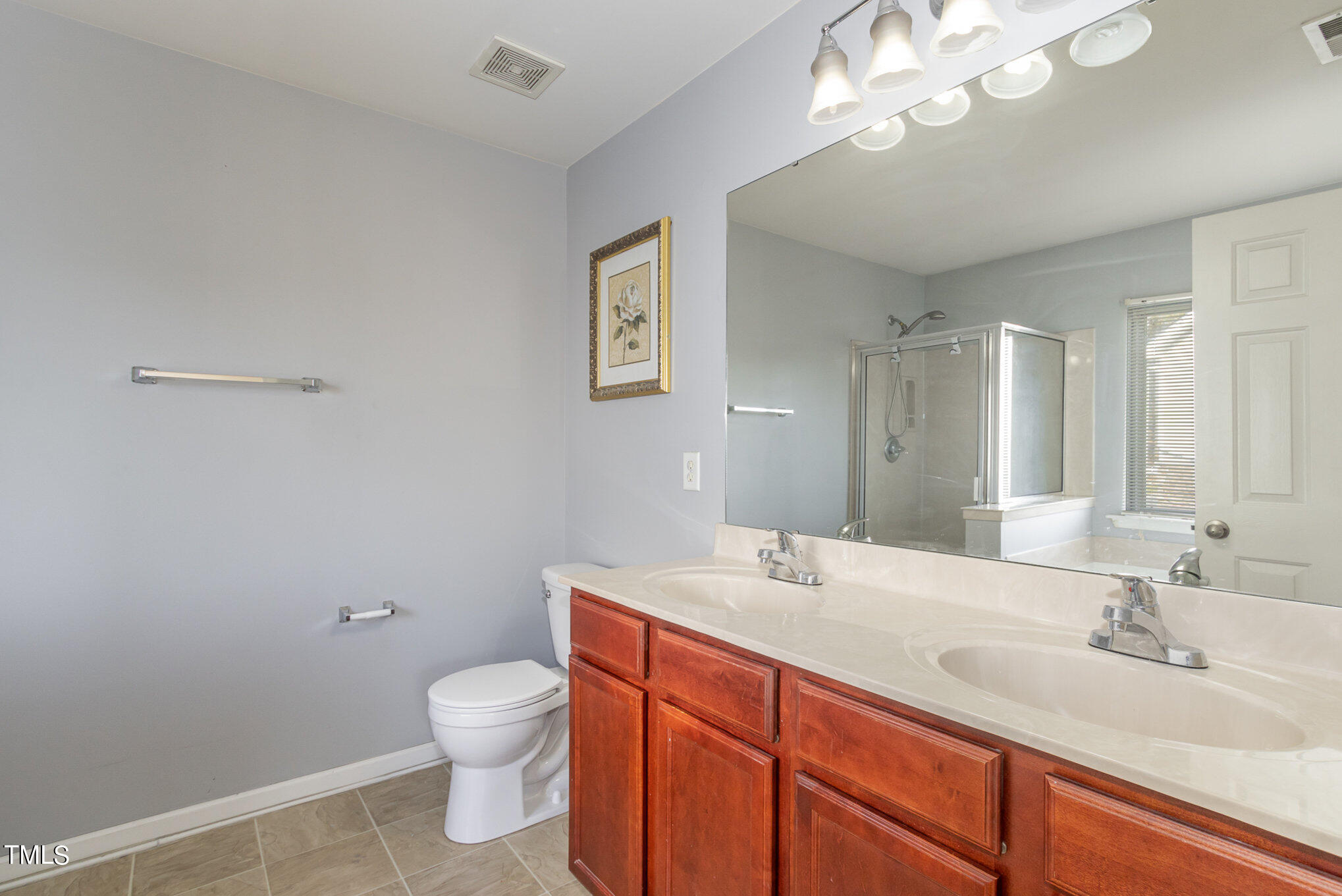 650 Conover Road Durham, NC 27703 - Photo 20 of 25 a bathroom with a toilet a sink and mirror