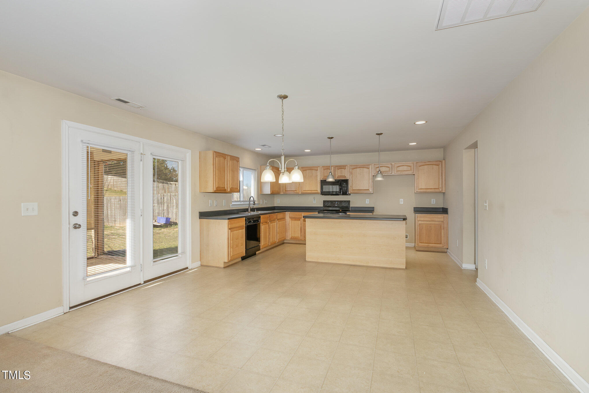 650 Conover Road Durham, NC 27703 - Photo 8 of 25 a large white kitchen with a refrigerator a stove a sink and white cabinets