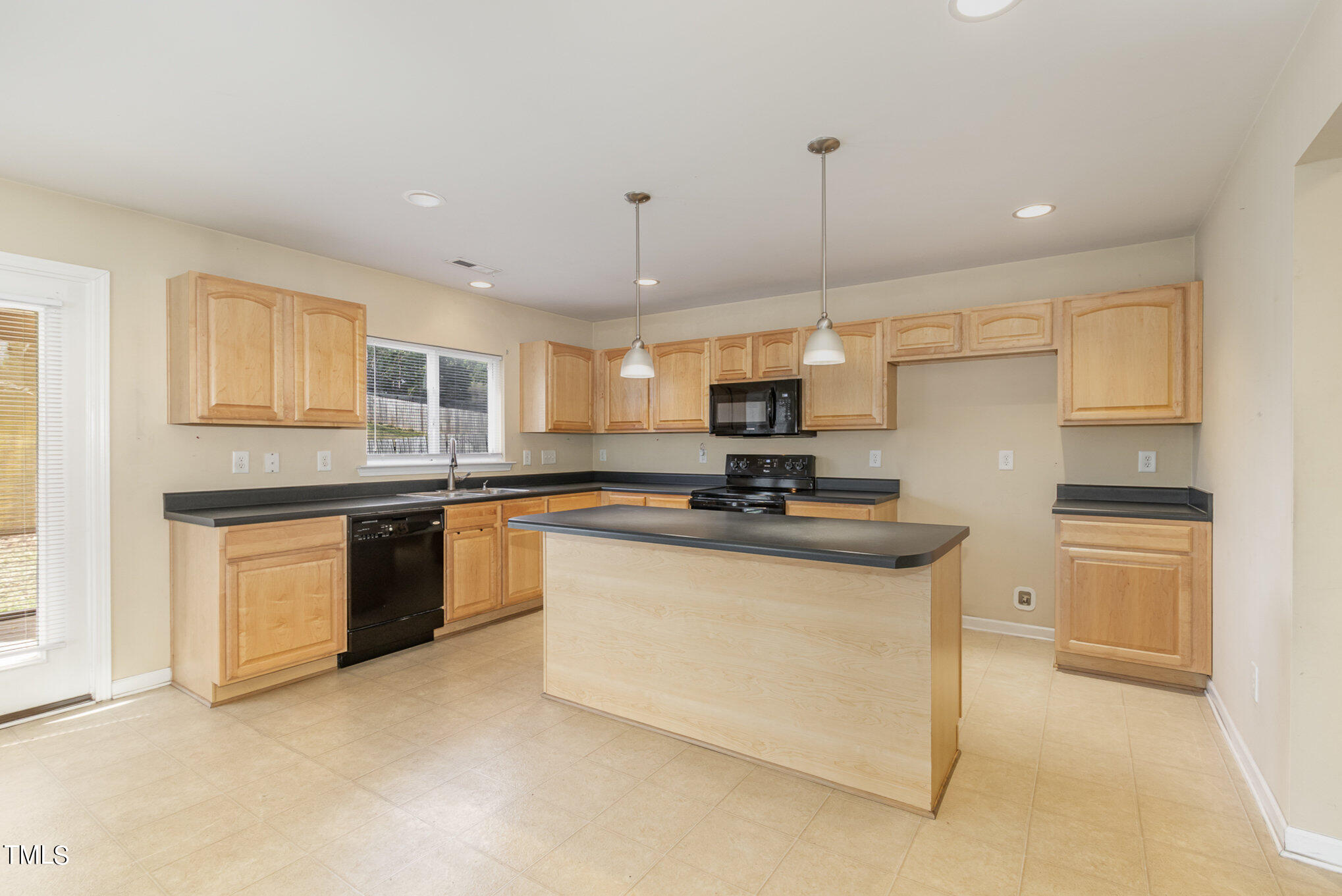 650 Conover Road Durham, NC 27703 - Photo 9 of 25 a kitchen with granite countertop a sink a counter top space stainless steel appliances and cabinets