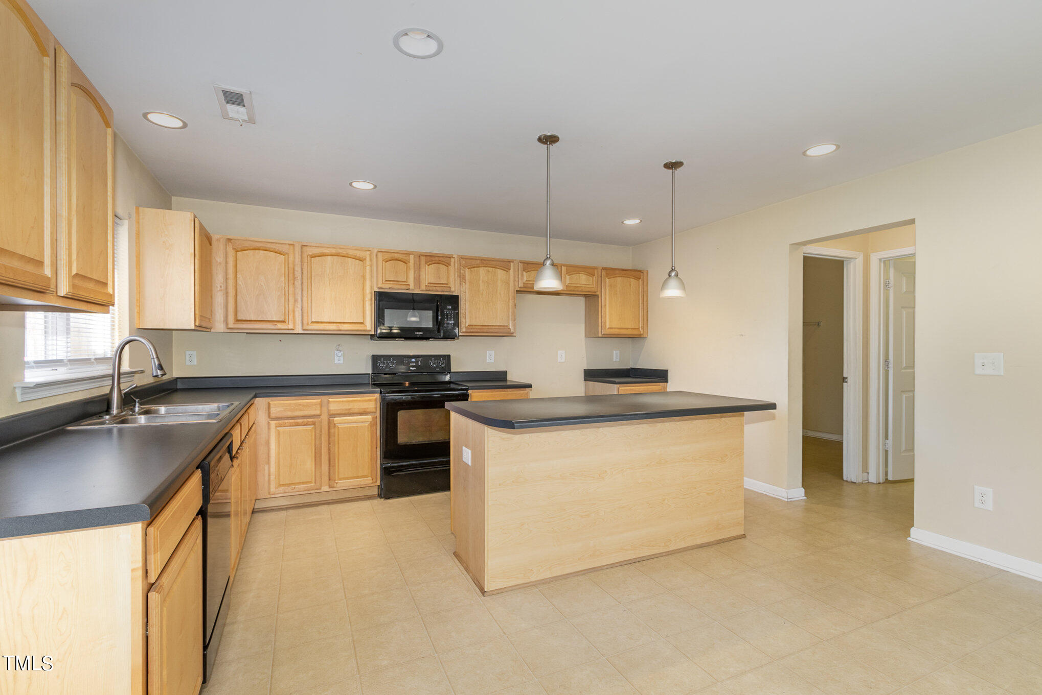 650 Conover Road Durham, NC 27703 - Photo 10 of 25 a kitchen with stainless steel appliances granite countertop a sink stove and refrigerator