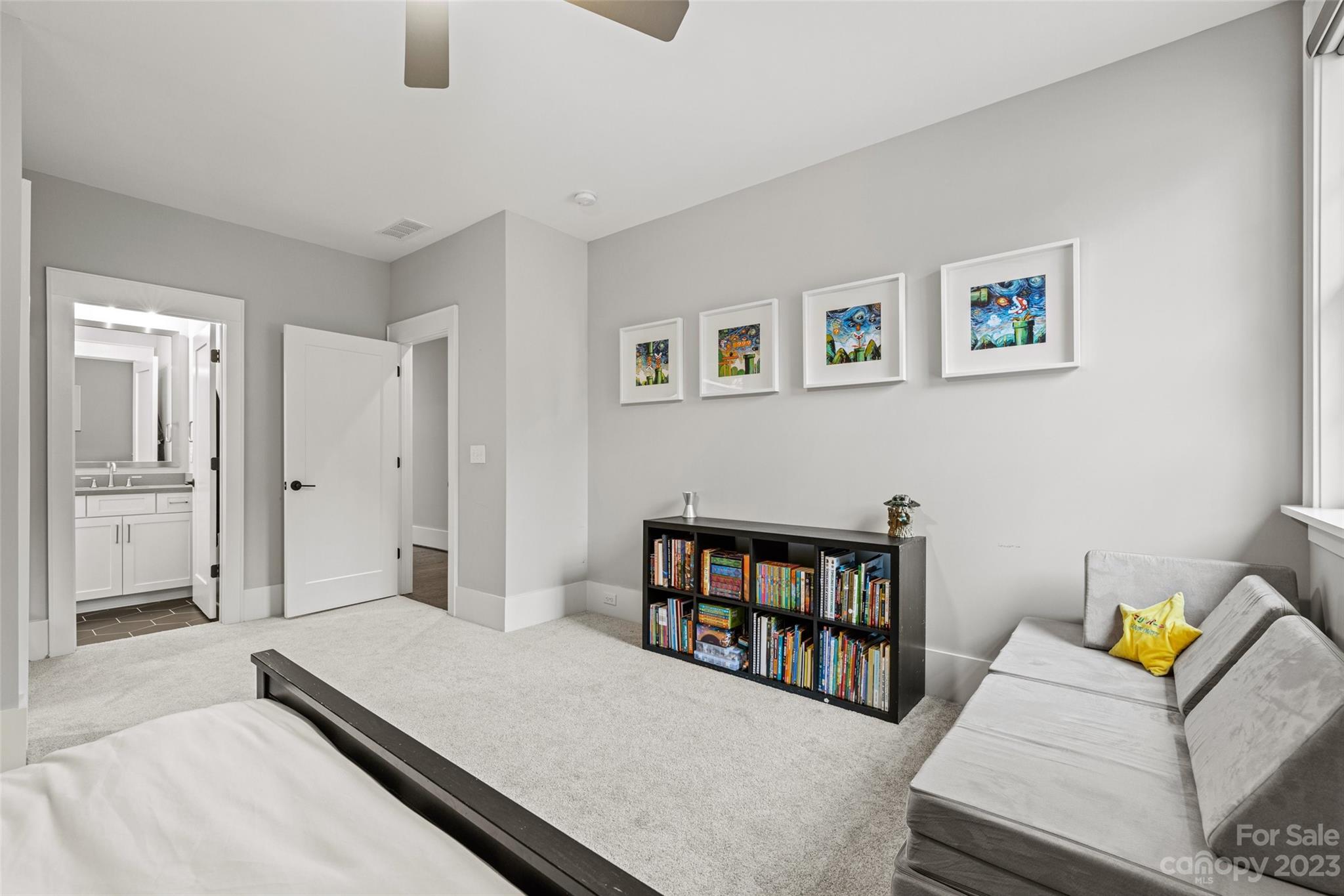 5524 Closeburn Road Charlotte, NC 28210 - Photo 33 of 44 a living room with furniture and a book shelf