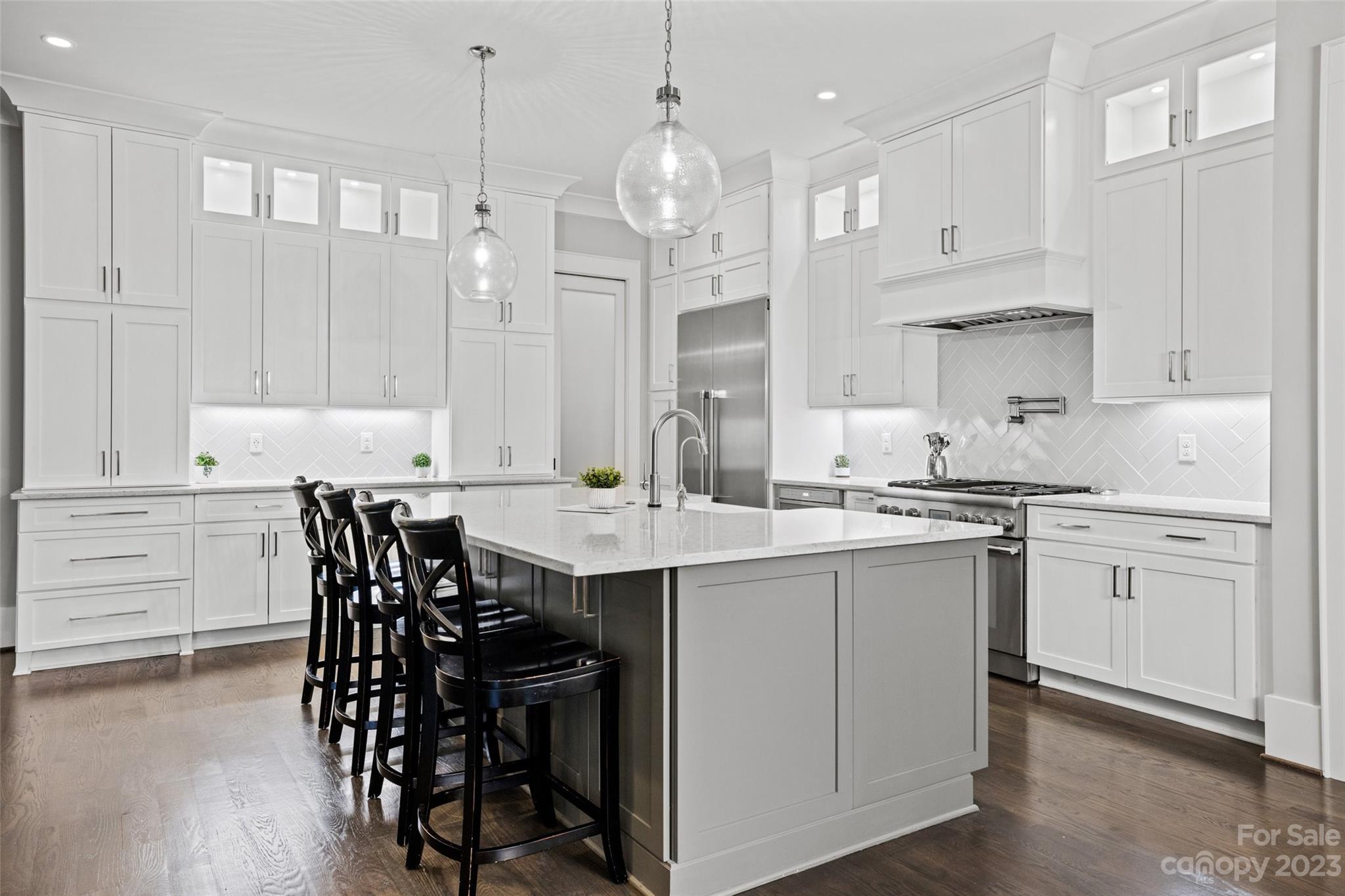 5524 Closeburn Road Charlotte, NC 28210 - Photo 9 of 44 a kitchen with kitchen island granite countertop a sink a center island and cabinets