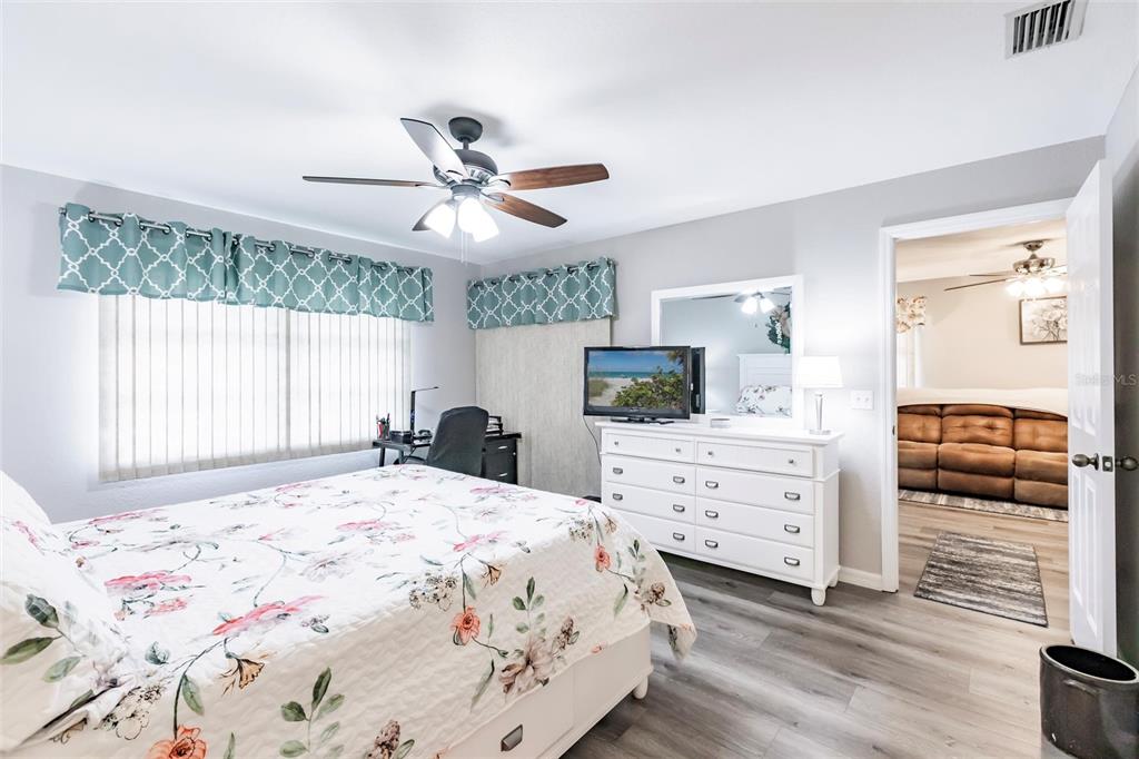 175 Kings Highway, Unit 538 Punta Gorda, FL 33983 - Photo 19 of 46 a bedroom with a bed a dresser and a window