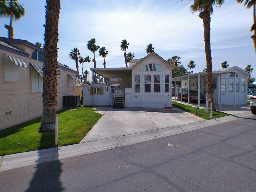 a front view of a house with a garden and yard