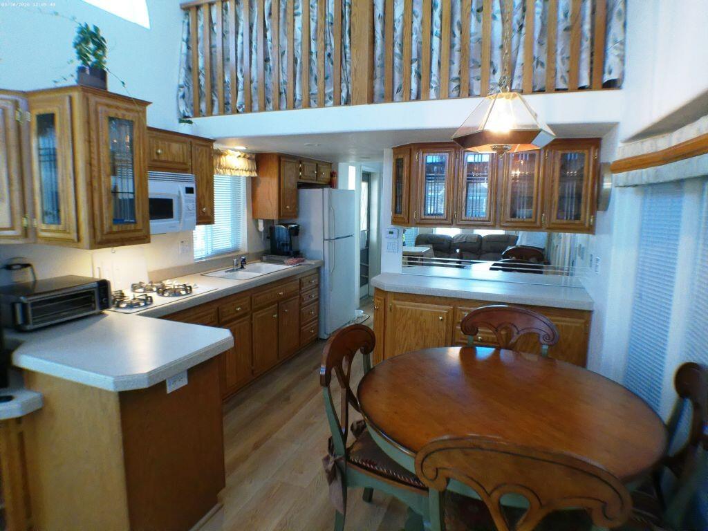 84136 Ave 44, Unit 582 Indio, CA 92203 - Photo 30 of 56 a kitchen with a table chairs stove and cabinets
