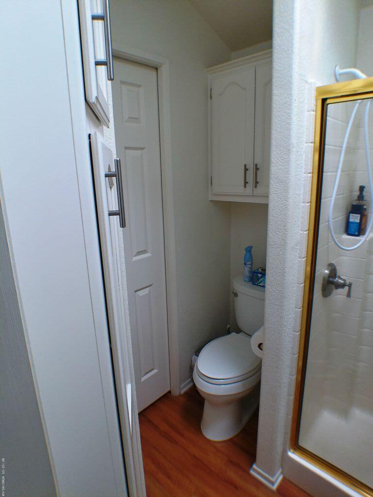 84136 Ave 44, Unit 582 Indio, CA 92203 - Photo 33 of 56 a white toilet sitting next to a sink and a mirror