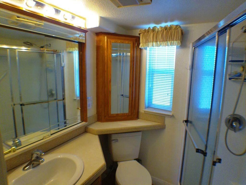 84136 Ave 44, Unit 582 Indio, CA 92203 - Photo 37 of 56 a bathroom with a sink toilet and shower