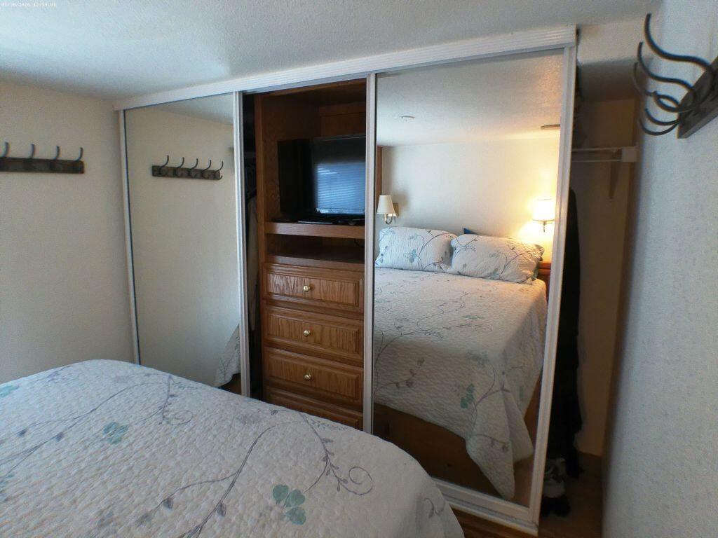 84136 Ave 44, Unit 582 Indio, CA 92203 - Photo 38 of 56 a bedroom with a bed and a mirror