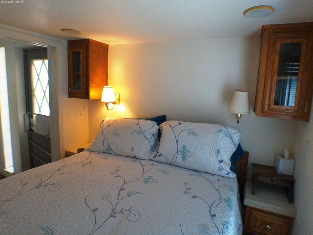 84136 Ave 44, Unit 582 Indio, CA 92203 - Photo 41 of 56 a bedroom with a bed and a lamp