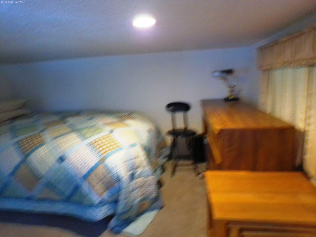84136 Ave 44, Unit 582 Indio, CA 92203 - Photo 53 of 56 a bedroom with a bed and lamp