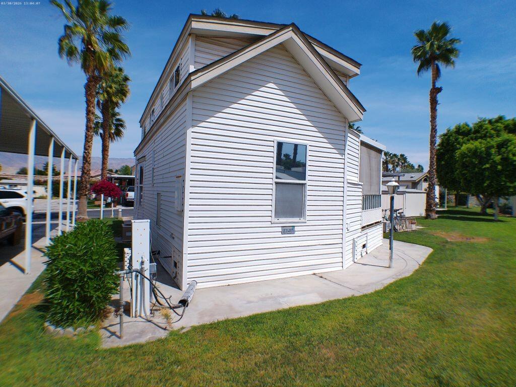 84136 Ave 44, Unit 582 Indio, CA 92203 - Photo 8 of 56 a front view of a house with a yard