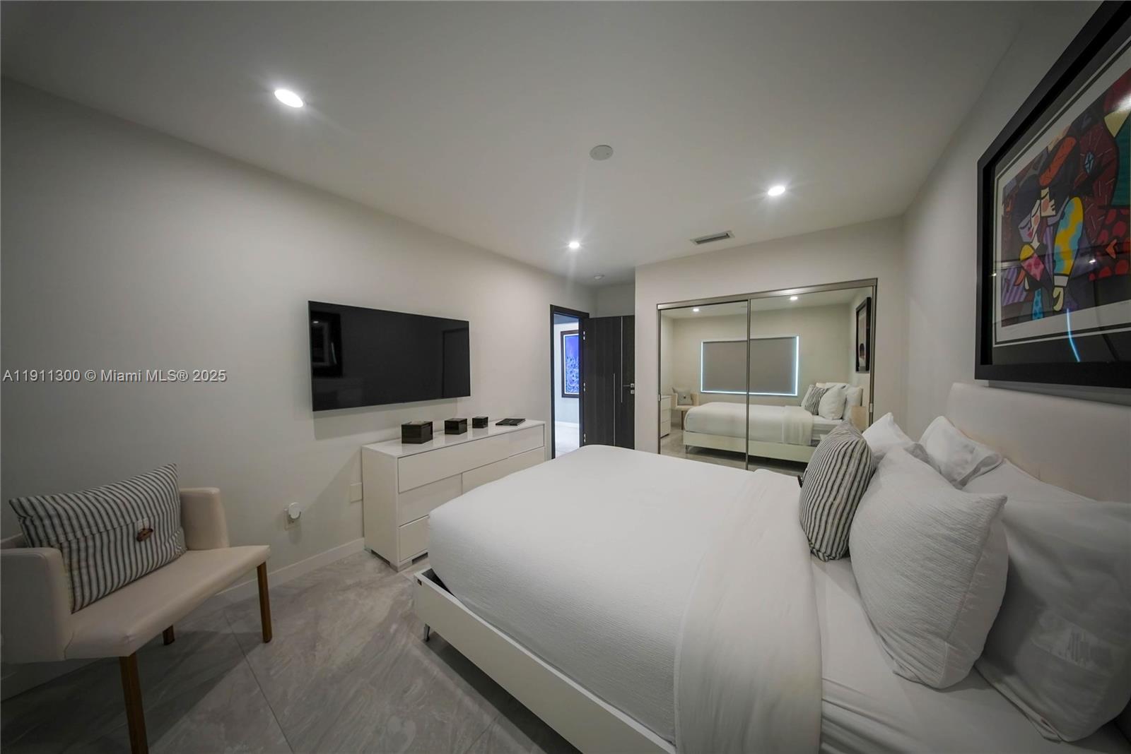 1242 Northeast 81st Terrace Miami, FL 33138 - Photo 11 of 23 a bedroom with a bed a television and a large window