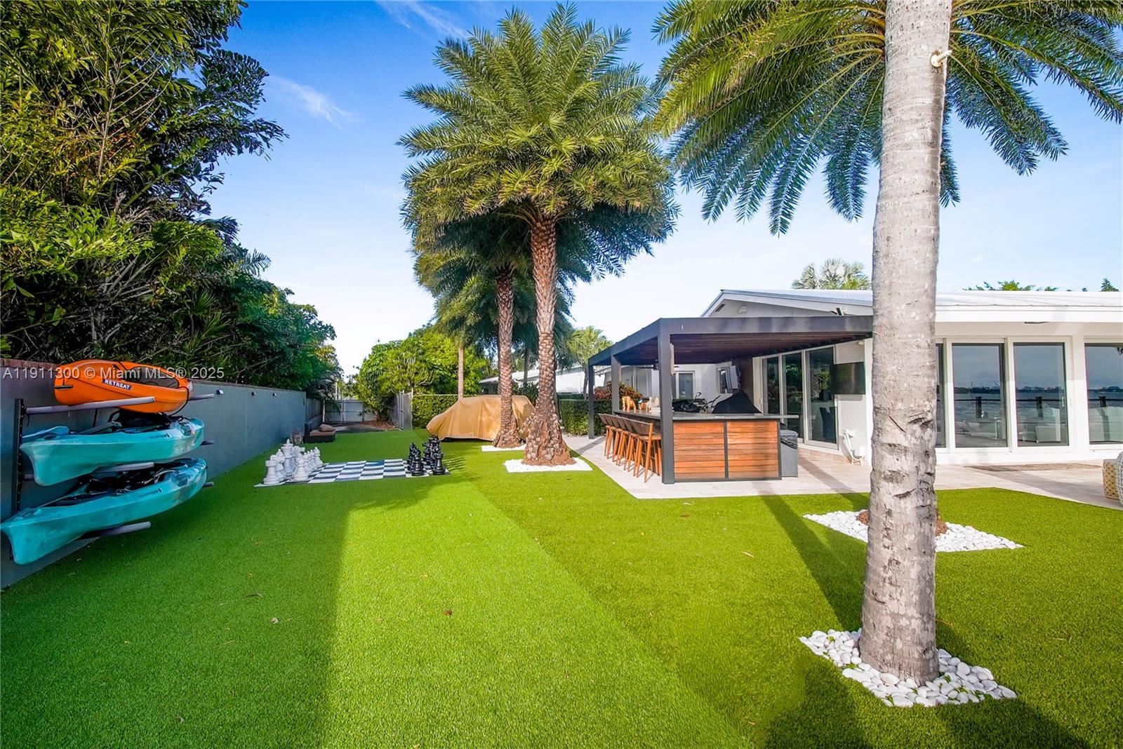 1242 Northeast 81st Terrace Miami, FL 33138 - Photo 16 of 23 a view of a house with swimming pool and porch with furniture