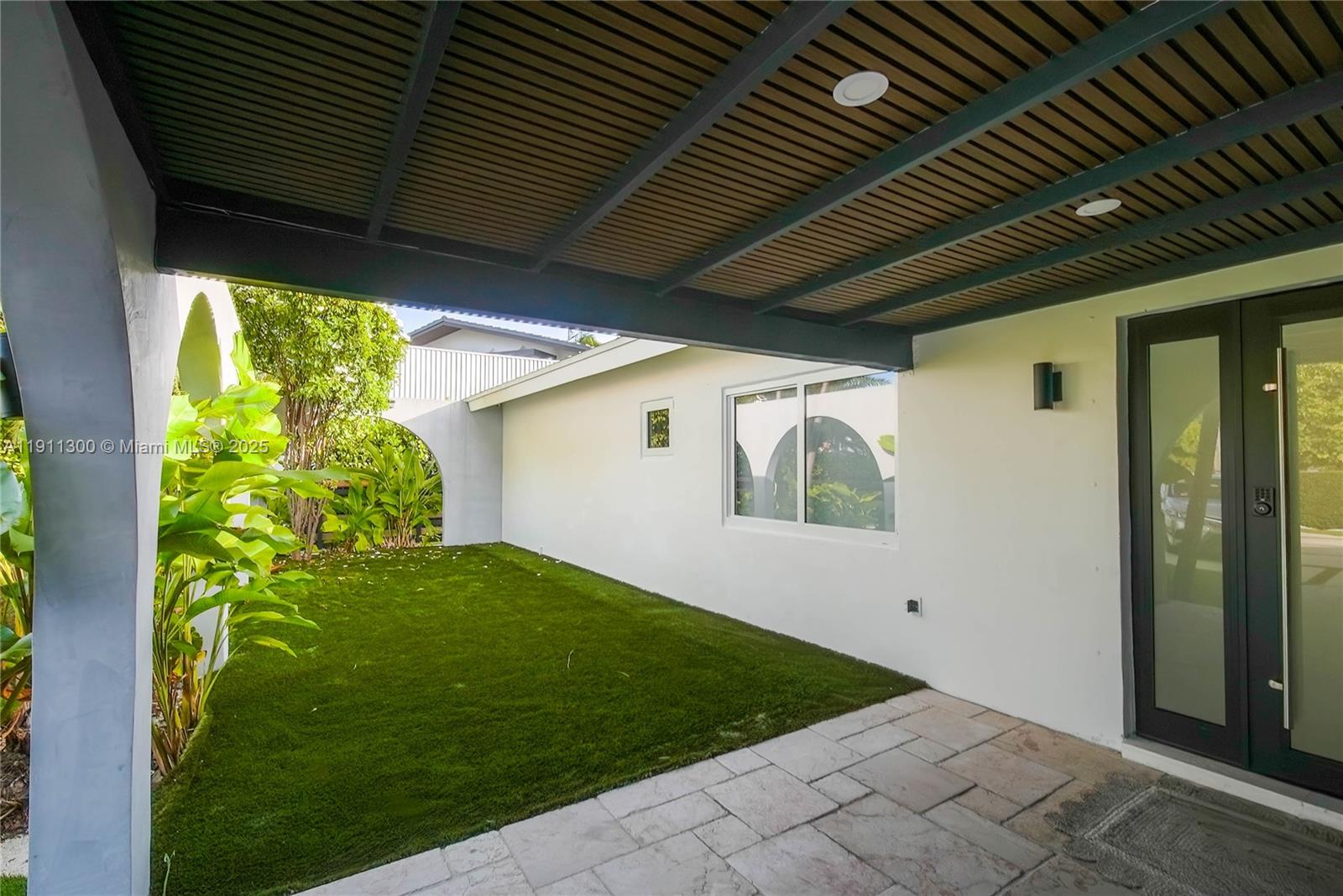 1242 Northeast 81st Terrace Miami, FL 33138 - Photo 20 of 23 a backyard of a house with garden