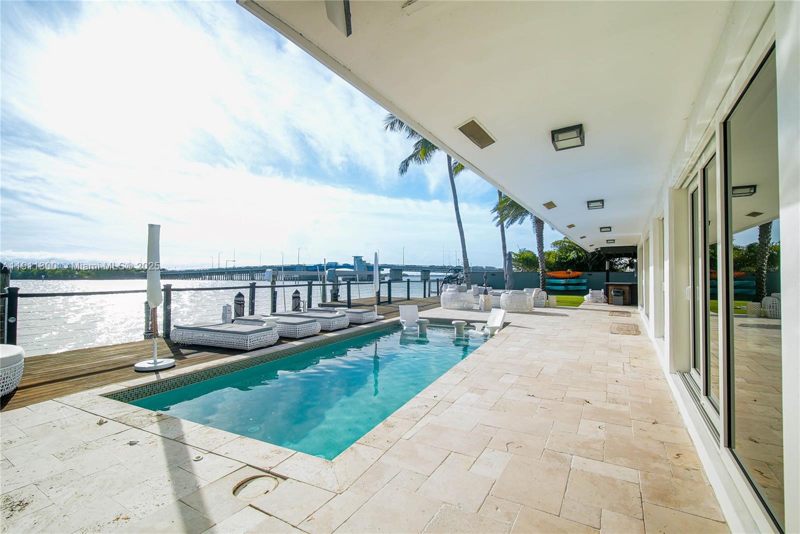 1242 Northeast 81st Terrace Miami, FL 33138 - Photo 23 of 23 a view of a swimming pool with outdoor seating and plants