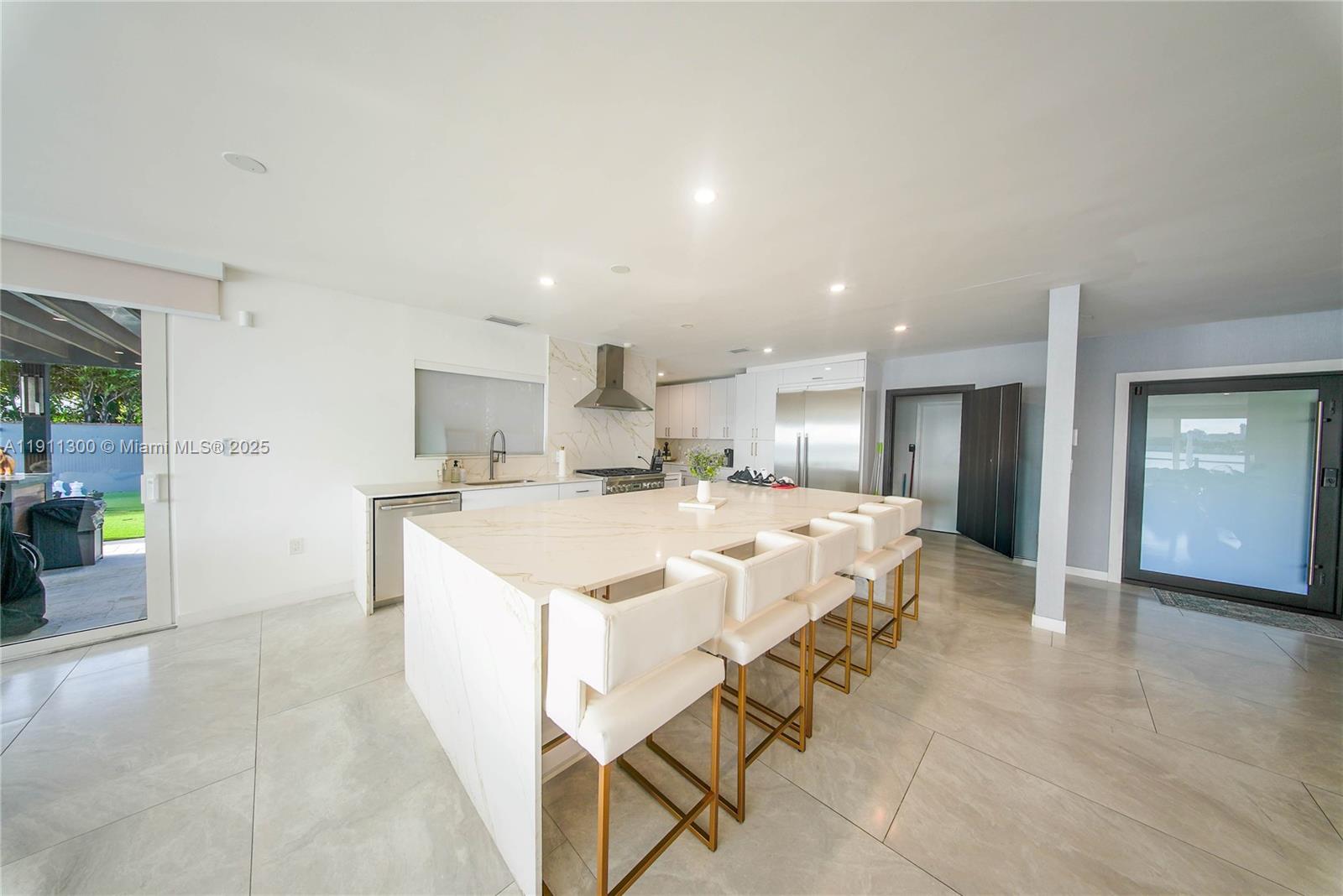 1242 Northeast 81st Terrace Miami, FL 33138 - Photo 6 of 23 a large white kitchen with a large window