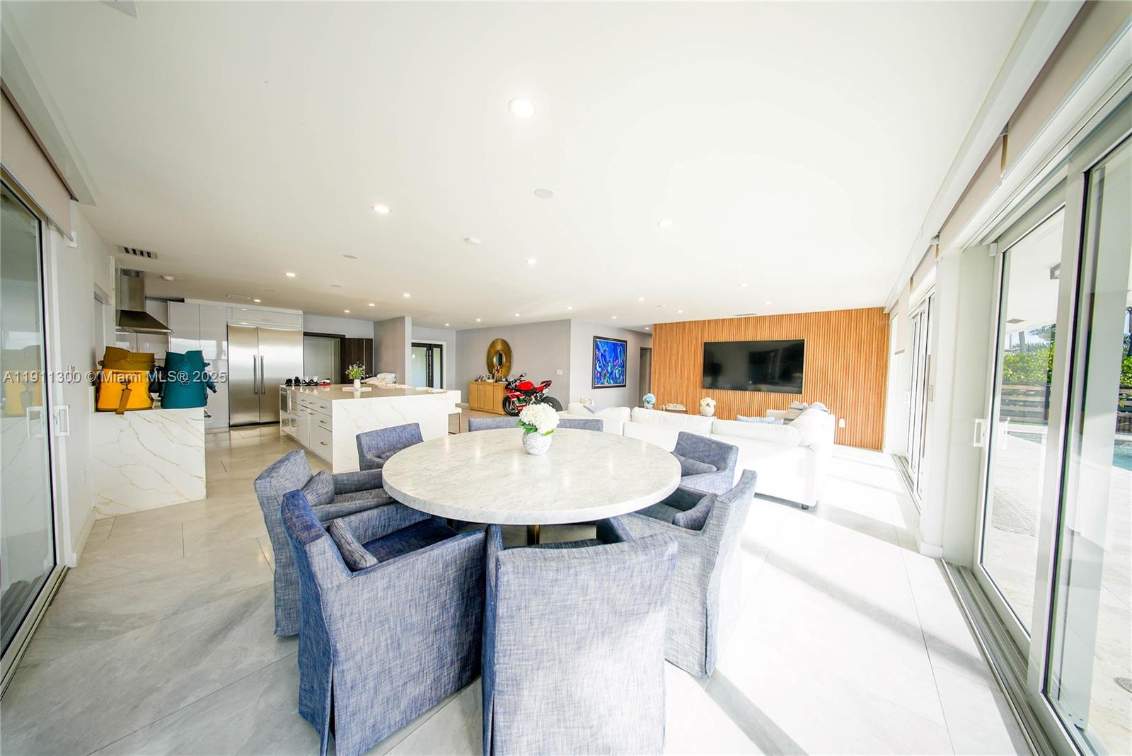 1242 Northeast 81st Terrace Miami, FL 33138 - Photo 10 of 23 a living room with furniture and a dining table with wooden floor