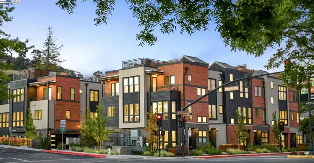 front view of a residential apartment building with a yard