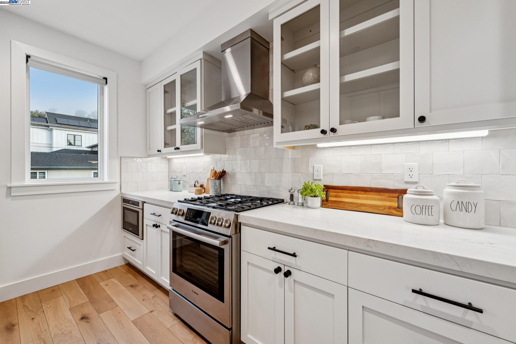 922 Brown Avenue Lafayette, CA 94549 - Photo 11 of 45 a kitchen with stainless steel appliances granite countertop white cabinets and a stove top oven