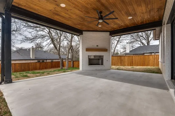 an empty room with wooden floor and outdoor view