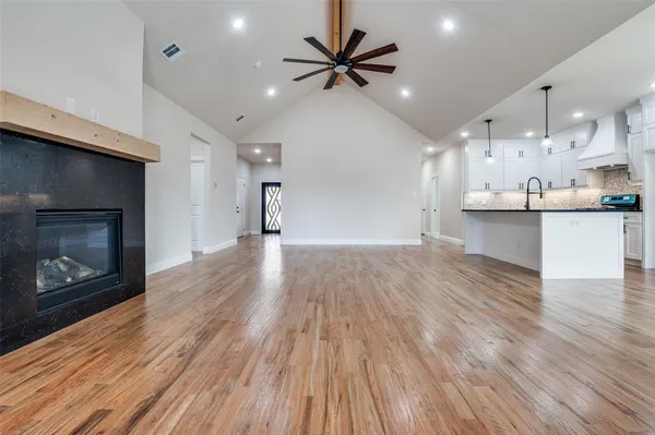 a view of a kitchen with a sink and a fireplace