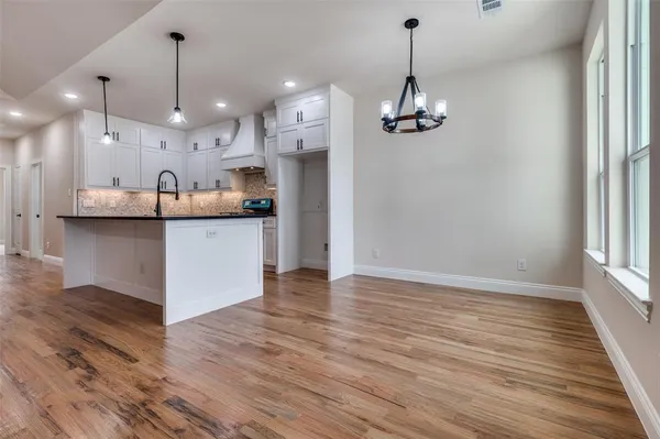 a view of a kitchen with a sink stainless steel appliances and cabinets
