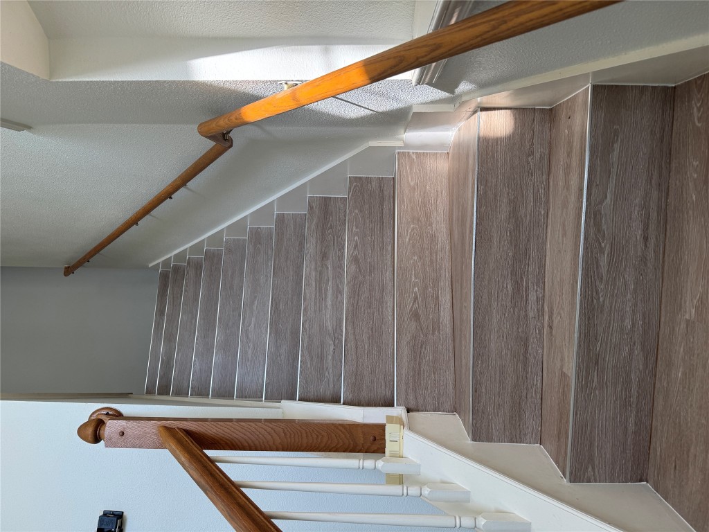 12714 Tantara Drive Austin, TX 78729 - Photo 11 of 25 Stairway with wood finished floors